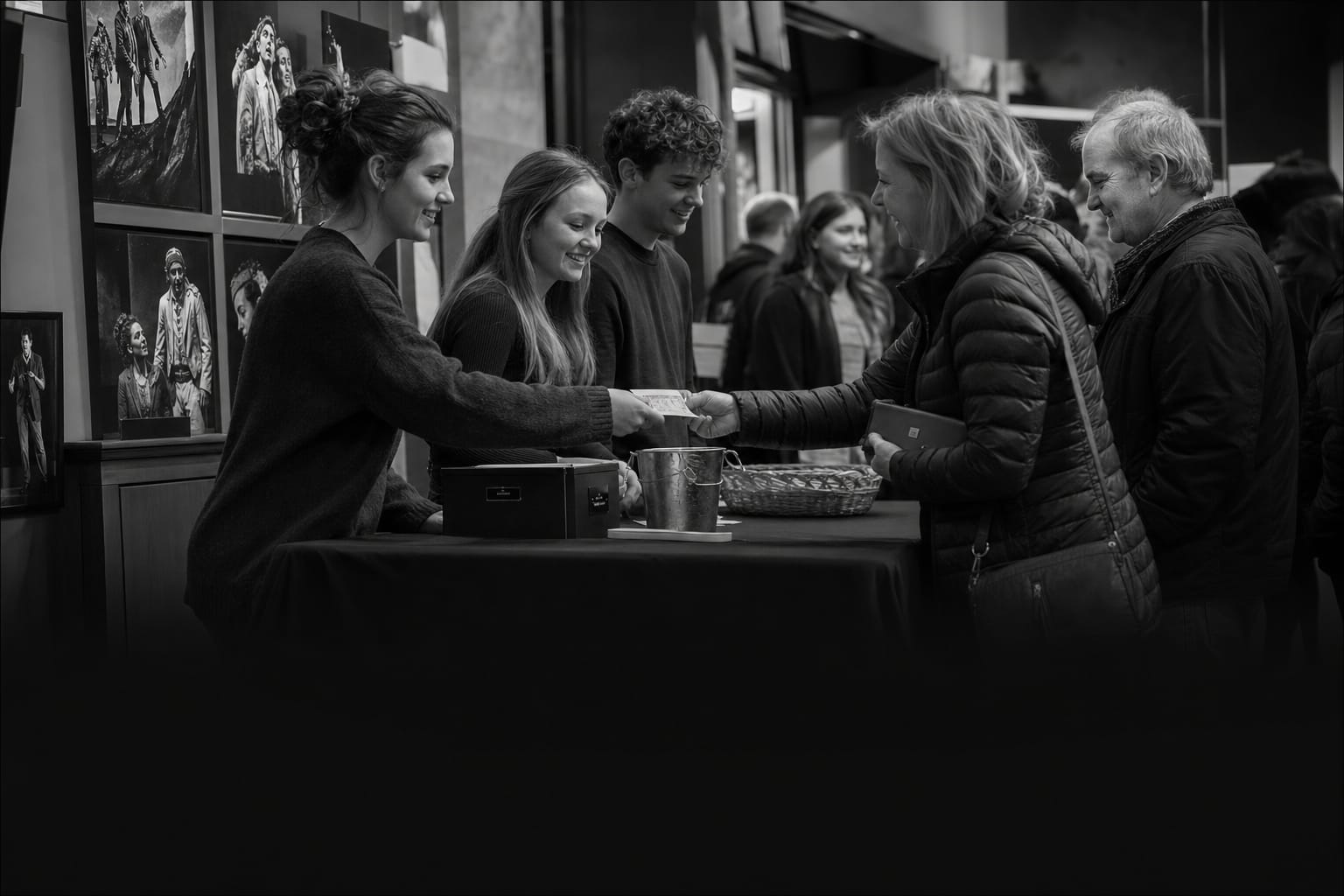 A film festival lobby where staff review box-office and royalty numbers between screenings
